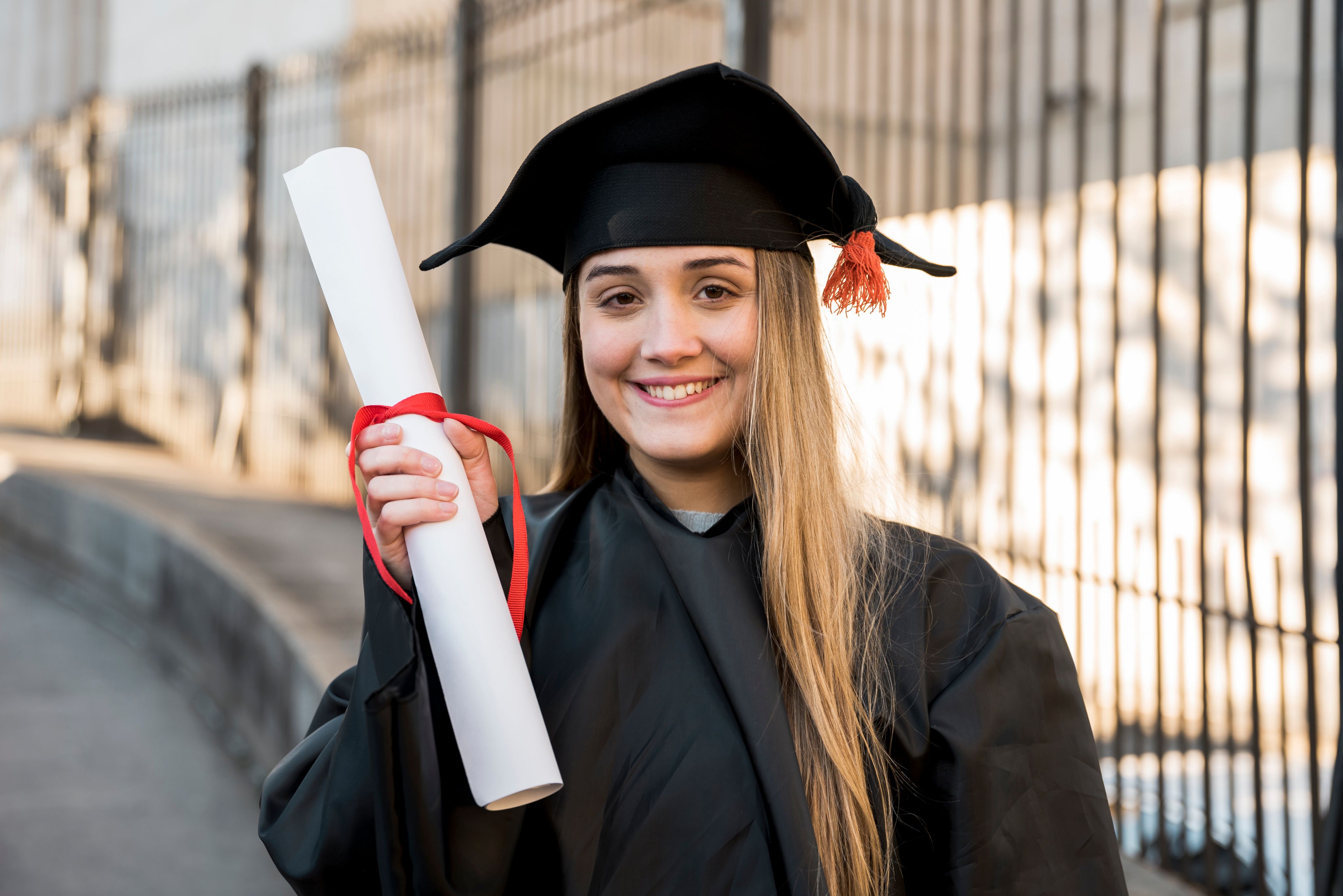 Student holding graduation certificate
