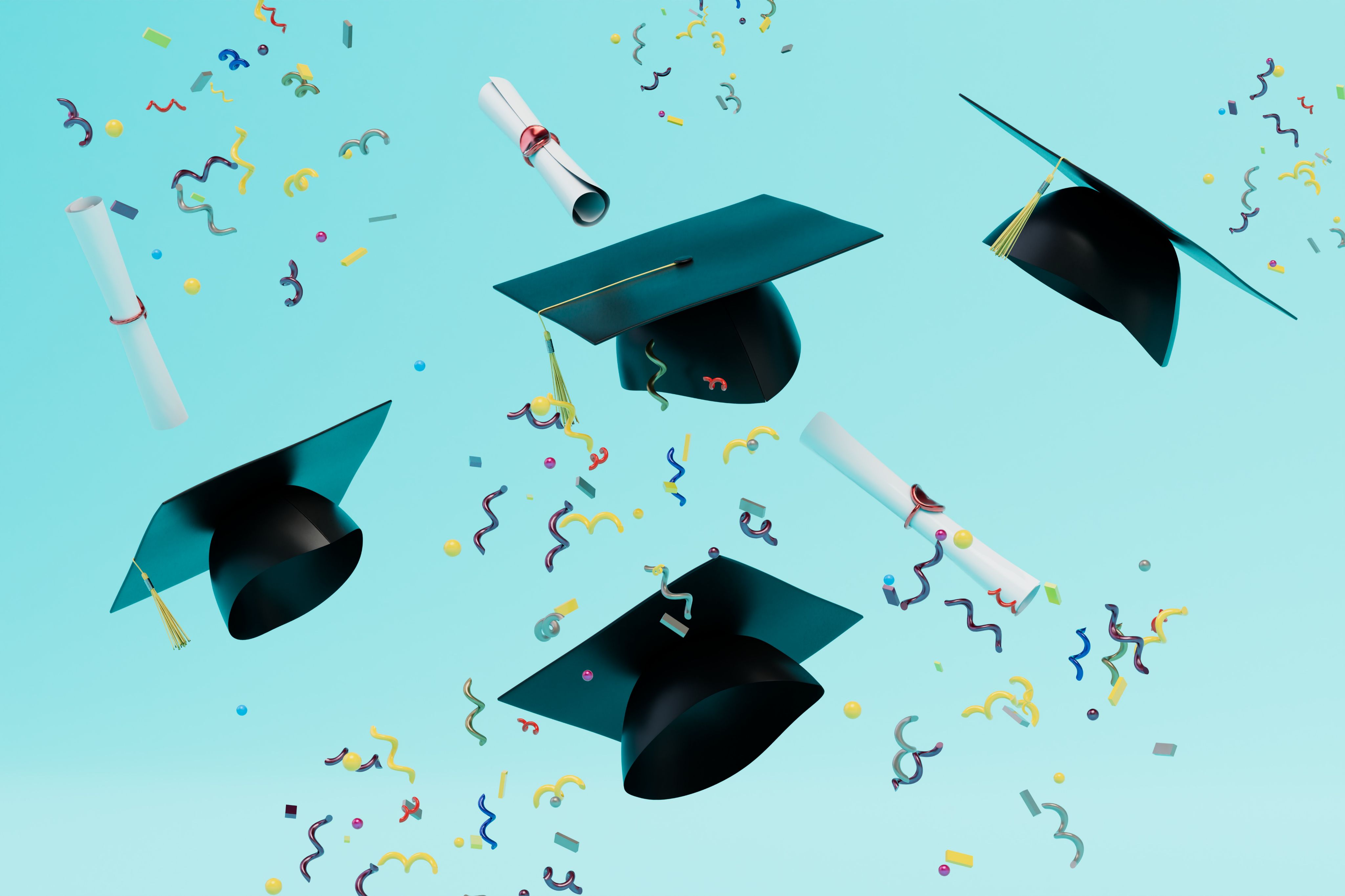 Graduation hats and diplomas flying with confetti